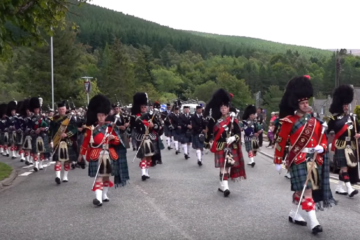 Massed Pipes & Drums parade through Deeside town to start the Ballater Highland Games 2018