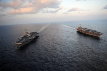 120119-N-YL945-045 ARABIAN SEA (Jan. 19, 2012) The Nimitz-class aircraft carriers USS Abraham Lincoln (CVN 72) and USS John C. Stennis (CVN 74) join for a turnover of responsibility in the Arabian Sea. Both ships are deployed to the U.S. 5th Fleet area of responsibility. (U.S. Navy photo by Mass Communication Specialist 2nd Class Colby K. Neal/Released)